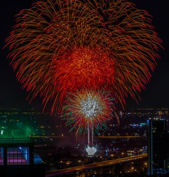 Colorful Firework with cityscape night light view of Bangkok skyline at twilight time. New Year celebration fireworks, Bangkok city,Thailand Fireworks light up to sky at Christmas & New Year festival with free space for text. Focus and blur.