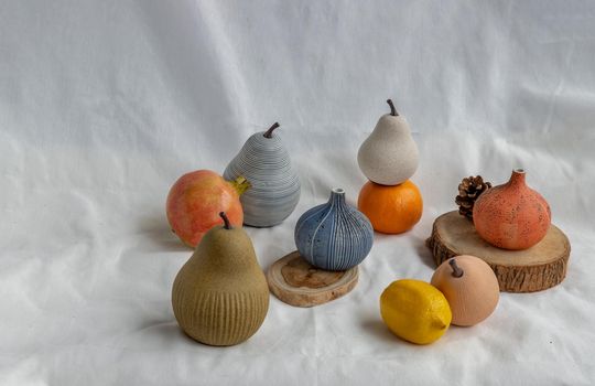 Beautiful small ceramic vases and Fresh fruits on white background. Ceramic tableware, Copy space.