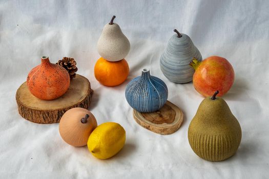 Beautiful small ceramic vases and Fresh fruits on white background. Ceramic tableware.