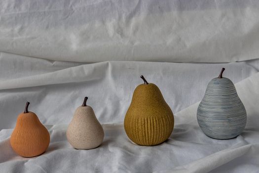 Ceramics pear fruits collection on white background. Ceramics tableware, Home decor, Copy space.