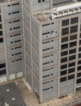 Group of workers cleaning windows service on high rise office building. Selective focus.