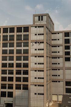 Group of workers cleaning windows service on high rise office building. Selective focus.