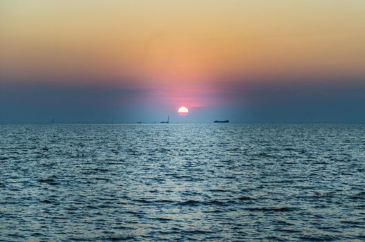 Beautiful​ Sunset​ Sky​ above​ the ocean​ with reflection. Selective focus.