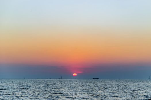 Beautiful​ Sunset​ Sky​ above​ the ocean​ with reflection. Selective focus.