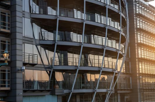 London, England - Apr 20, 2019 : Modern building with repeating structure and reflected sky and clouds. Architecture concept, No focus, specifically.