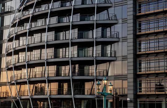 London, England - Apr 20, 2019 : Modern building with repeating structure and reflected sky and clouds. Architecture concept, No focus, specifically.