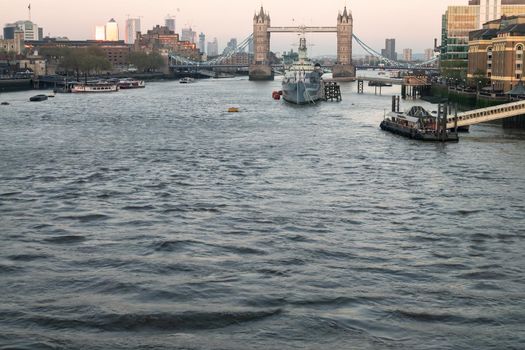 London, England - Apr 20, 2019 : HMS Belfast is a Town-class light cruiser that was built for the Royal Navy. She is now permanently moored as a museum ship in front of Tower Bridge on the River Thames, No focus, specifically.
