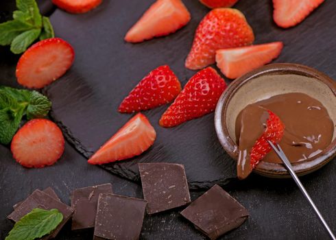 Composition with chocolate covered strawberries on grey background