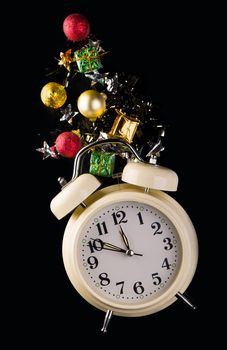 Christmas or New Year composition with retro alarm clock and Christmas decorations - stars, confetti, balls and gift boxes