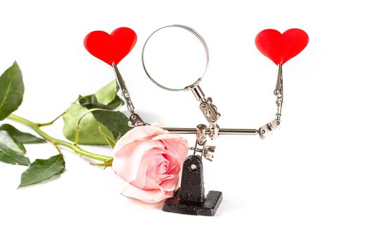.Abstract Valentines Day background with engineering tool third hand holding hearts and rose on white background