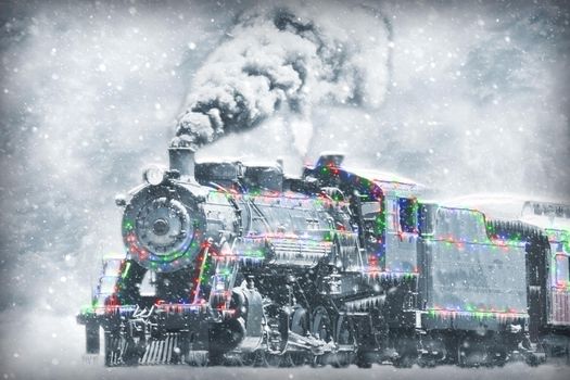A Restored Steam Engine With Christmas Lights on it in a Snow Storm