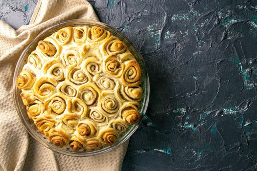 Apple pie with cinnamon on retro wooden background. Top views with clear space.