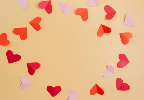 Valentine's Day background. Pink and red hearts on a pastel yellow background. Valentine's Day concept. Flat lay, top view, copy space