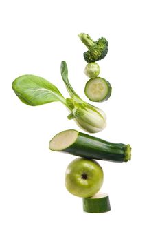 Group of green vegetables and fruits on white background