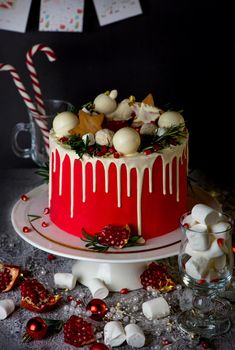 Christmas or New Year decorated cake with cream cheese frosting and cranberries