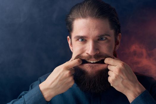 Emotional man black shirt attractive look close-up smoke in the background. High quality photo