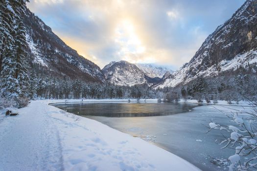 Idyllic winter landscape: Frosty lake and mountains. Buntausee