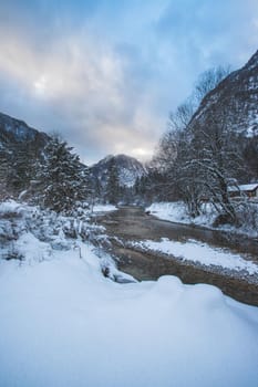 Idyllic winter landscape: Frosty river and mountains. Buntausee