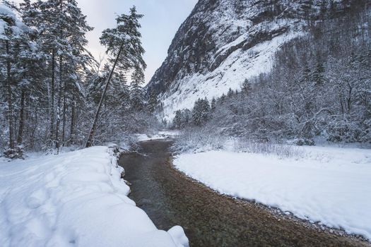 Idyllic winter landscape: Frosty river and mountains. Buntausee