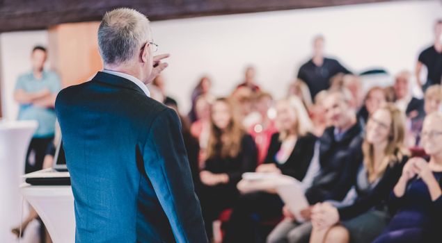 Business man leading a business workshop. Corporate executive delivering a presentation to his colleagues during meeting or in-house business training. Business and entrepreneurship concept.