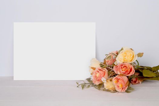 Valentine day, greeting card mockup empty and flower on wooden table, postcard blank with romance on desk, present in anniversary and celebration, paper for message with vertical, holiday concept.