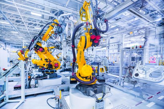 robotic arms in a car plant