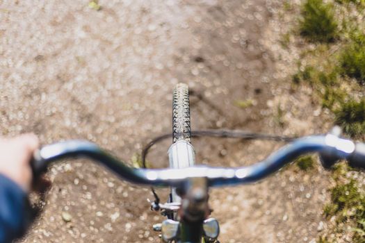 Close up picture of retro bike tire, blurry handlebar, summer day