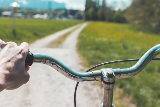 Closeup picture of a vintage bicycle handlebar and breaks outdoors, blurred background