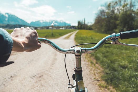 Closeup picture of a vintage bicycle handlebar and breaks outdoors, blurred background