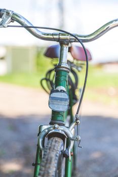 Front picture of a vintage retro bike, head reflectors and blurry background