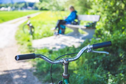 Closeup picture of a vintage bicycle handlebar and breaks outdoors, blurred background