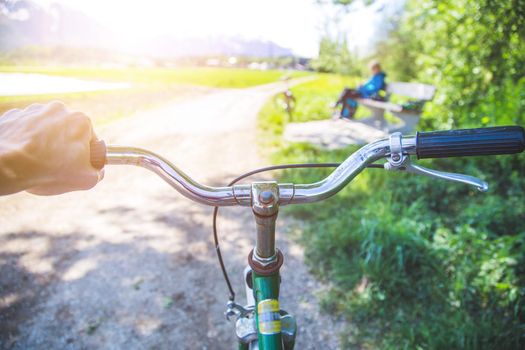 Closeup picture of a vintage bicycle handlebar and breaks outdoors, blurred background