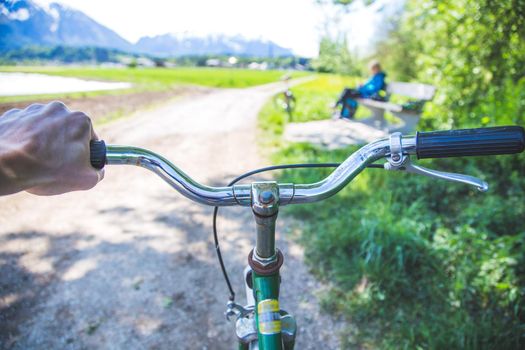 Closeup picture of a vintage bicycle handlebar and breaks outdoors, blurred background