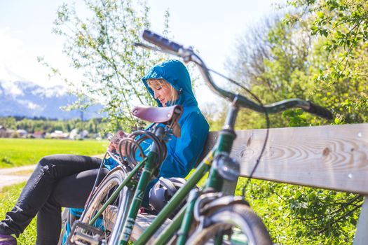 Front picture of a vintage retro bike, head reflectors. Girl sitting in blurry background.