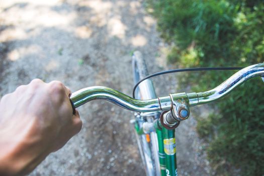 Closeup picture of a vintage bicycle handlebar and breaks outdoors, blurred background