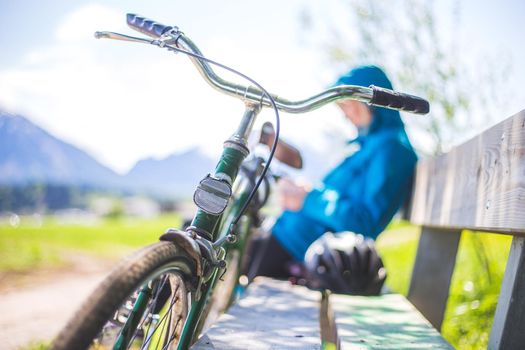 Front picture of a vintage retro bike, head reflectors. Girl sitting in blurry background.