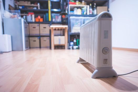 Electric heater, heating the basement. Blurry shelfs in the background