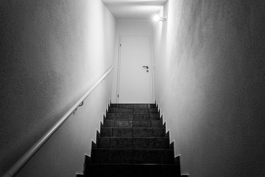 Basement stairs with balustrade, closed white door