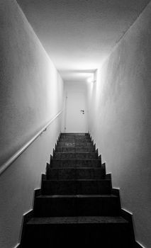 Basement stairs with balustrade, closed white door