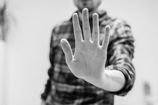Man showing stop gesture, close up of the hand