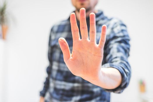 Man showing stop gesture, close up of the hand