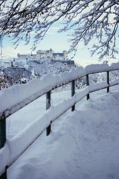 Walking promenade in Salzburg, snowy winter landscape