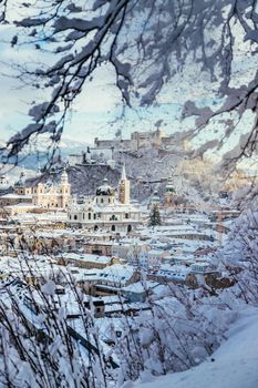 Panorama of Salzburg in winter: Snowy historical center, sunshine