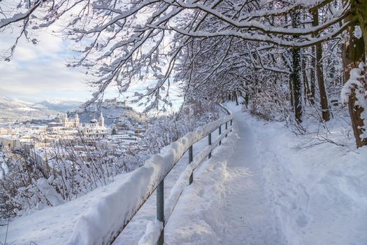 Walking promenade in Salzburg, snowy winter landscape