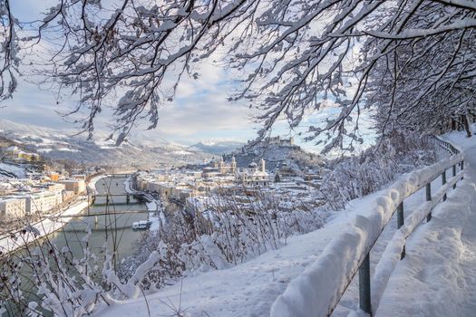Walking promenade in Salzburg, snowy winter landscape