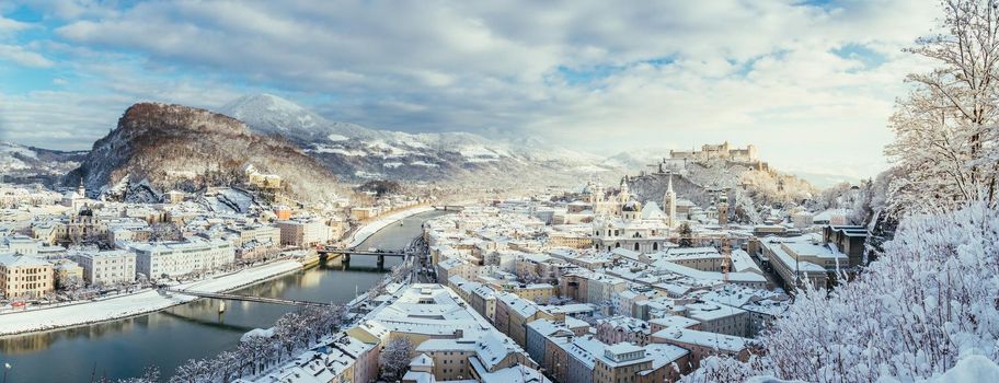 Panorama of Salzburg in winter: Snowy historical center, sunshine