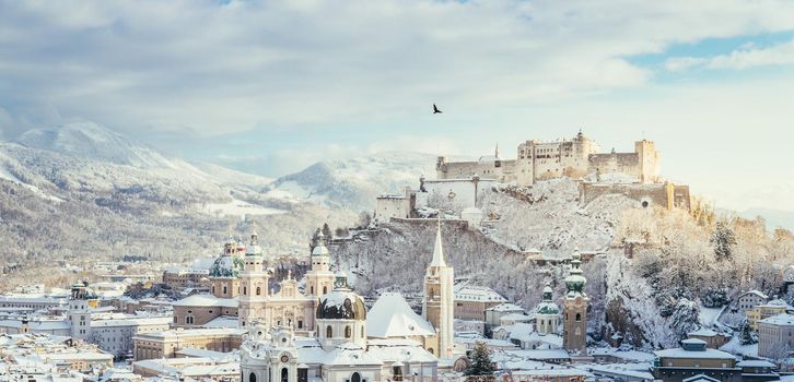 Panorama of Salzburg in winter: Snowy historical center, sunshine