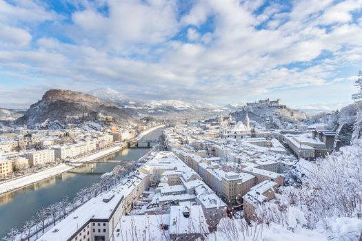 Panorama of Salzburg in winter: Snowy historical center, sunshine