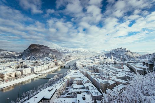 Panorama of Salzburg in winter: Snowy historical center, sunshine