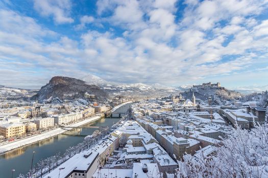 Panorama of Salzburg in winter: Snowy historical center, sunshine